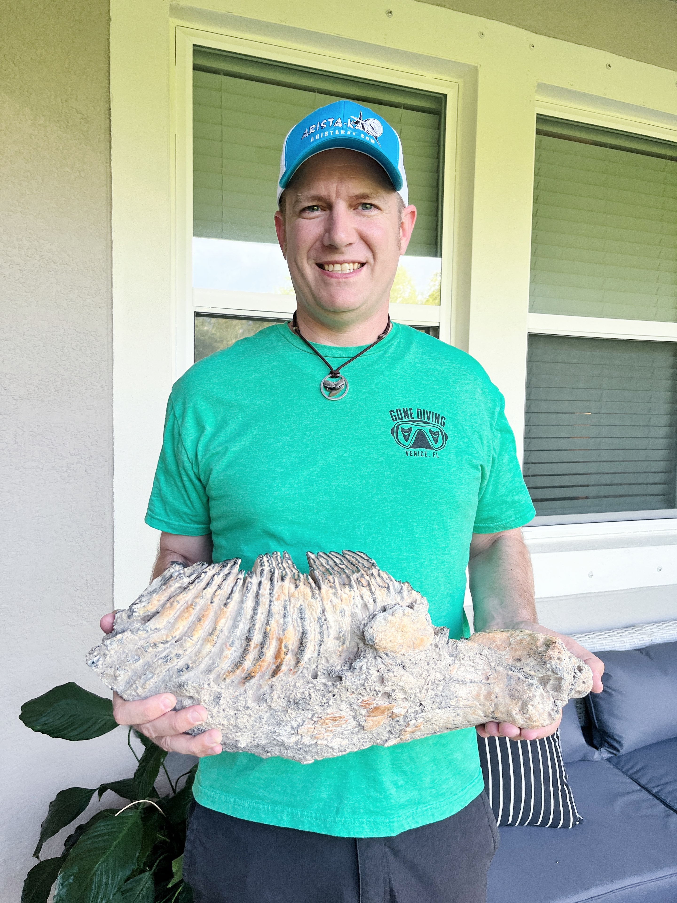 Museum curator holding a mammoth jaw fossil
